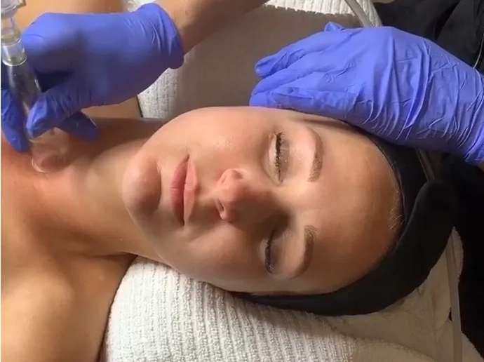 A woman getting her face waxed at the spa.