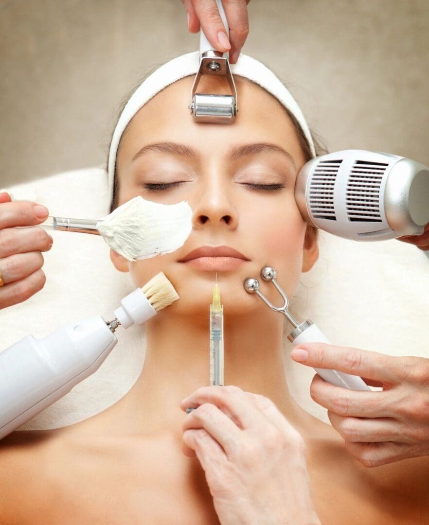 A woman getting her face cleaned by several hands.