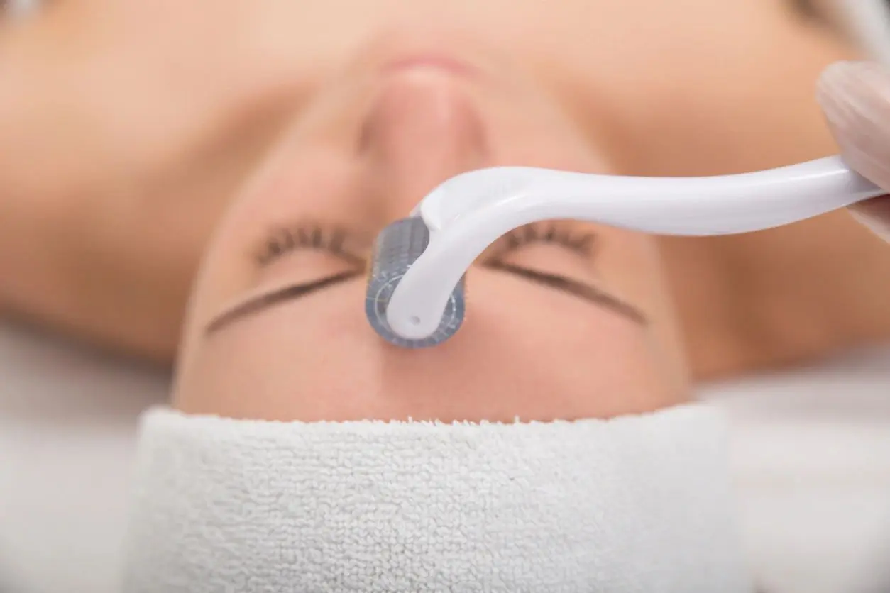 A woman is getting her face waxed at the spa.